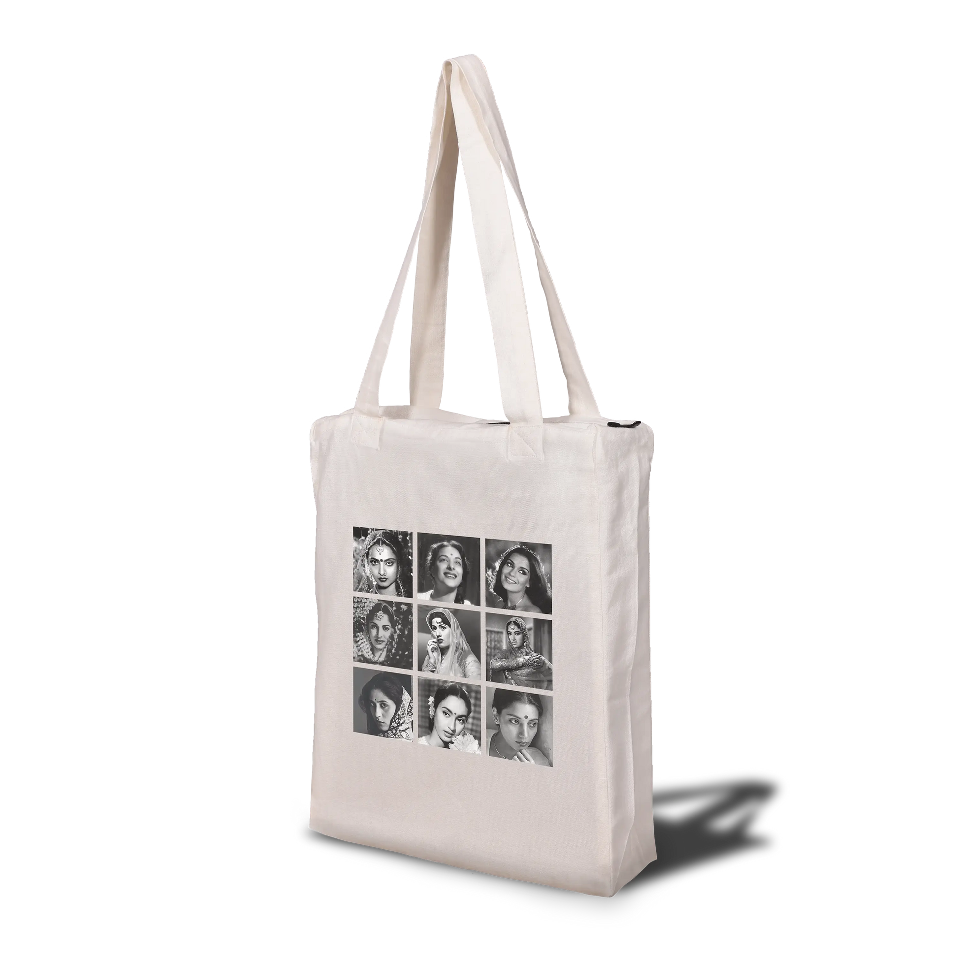 A beige tote bag featuring a zip closure and multiple handles, with a printed photo collage of Bollywood divas on the front.