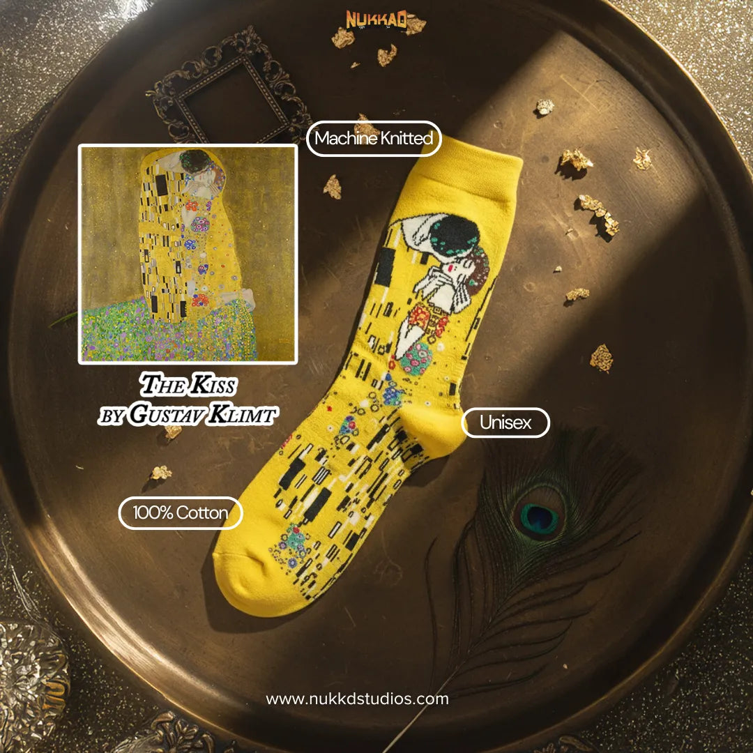 Yellow sock with artistic design on a decorative tray, inspired by Gustav Klimt's 'The Kiss'.