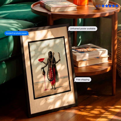 A framed art print leaning against a green sofa on a wooden floor, showing a vintage-style illustration of a dark-skinned deity figure in red and black clothing. The scene includes a round wooden side table with books, a green sofa, and text overlays mentioning Kodak-Fuj photo paper, unframed poster available, and free shipping.