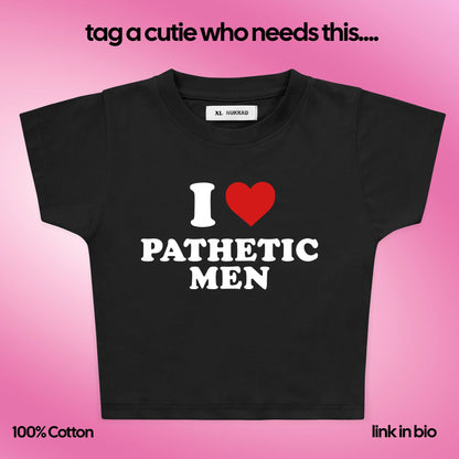 Black t-shirt with 'I ❤️ Pathetic Men' text on a pink background